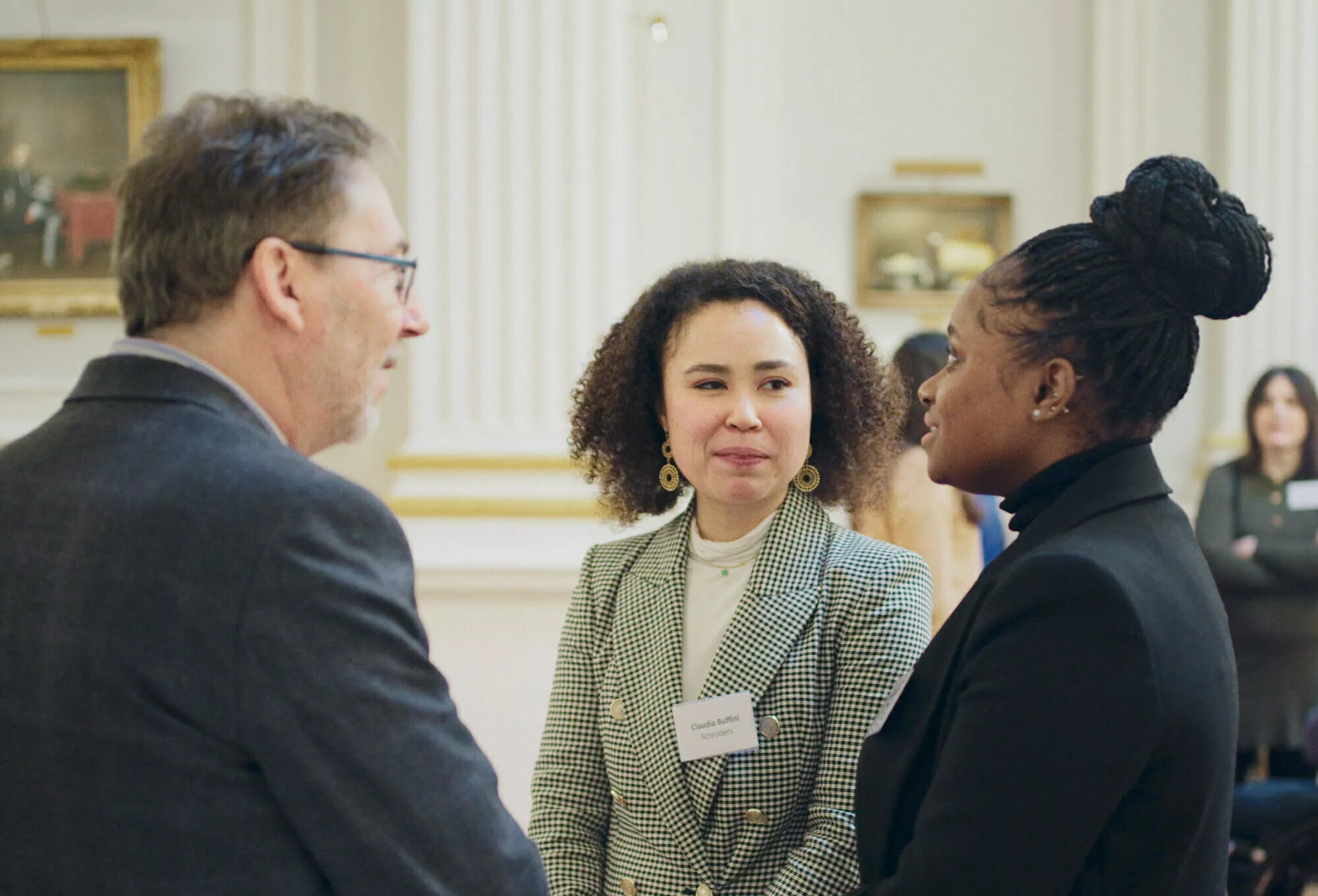 Image of Renny, our Chair of Trustees, talking to representatives from Schroders