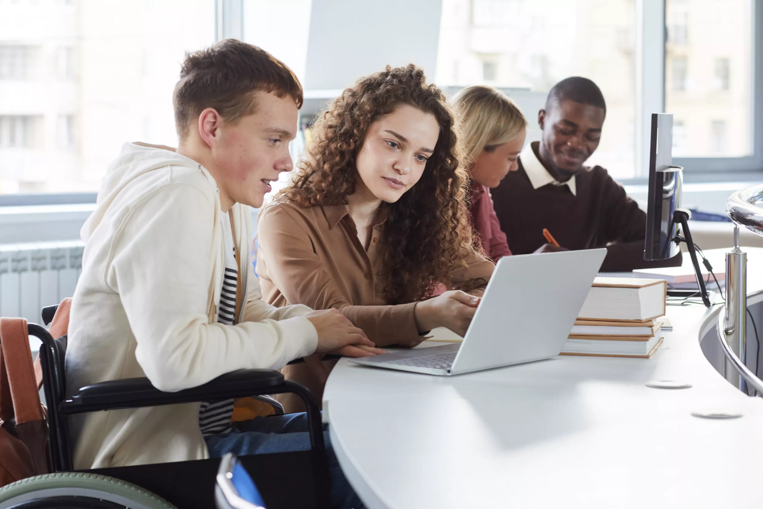 Image of students working together on a laptop