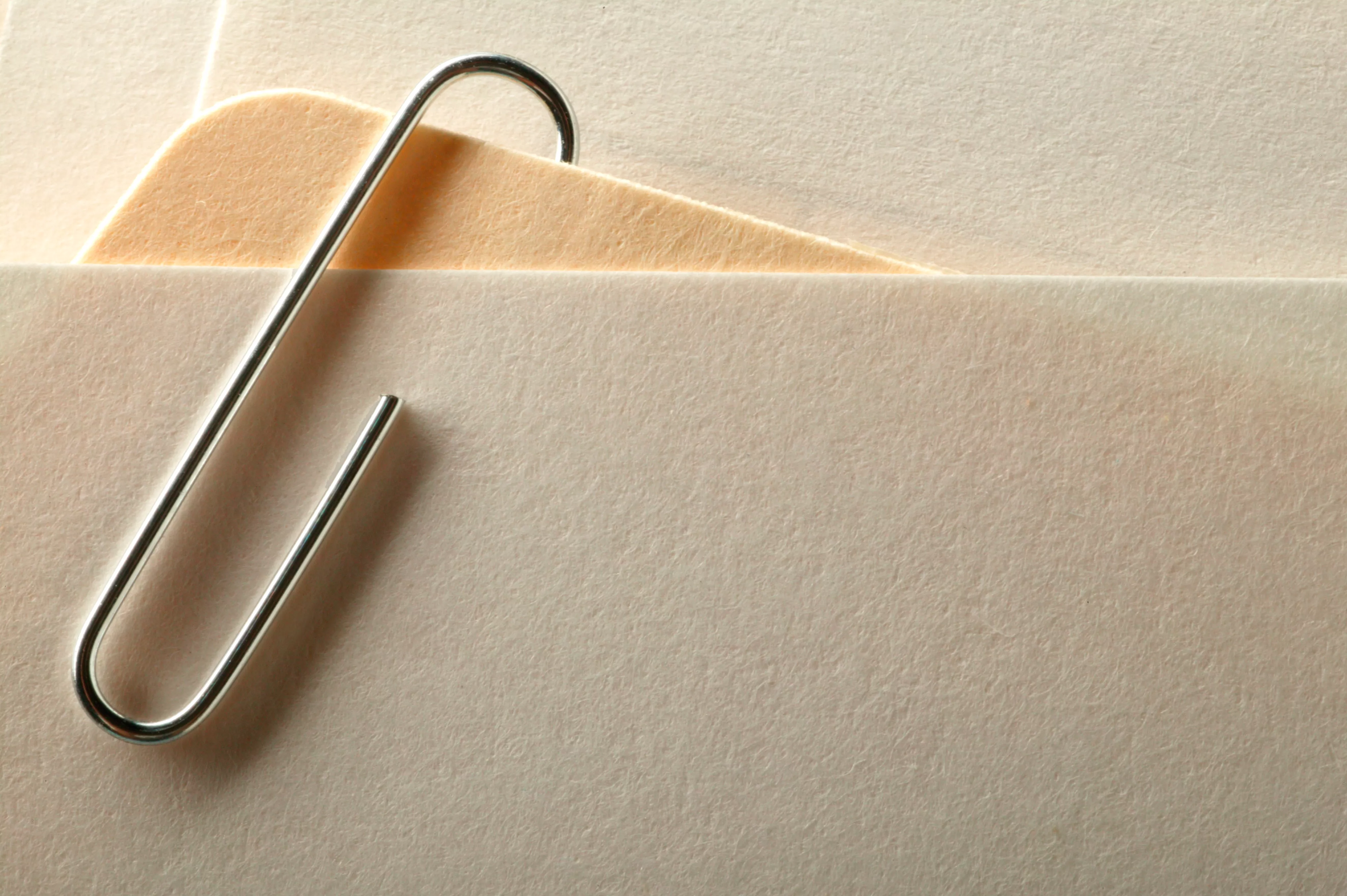 an image of sheets of paper held together with a paperclip